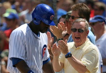 CHICAGO - JULY 26: Senator Richard Durbin (D-IL) joins Chicago Cub fans in cheering Milton Bradley #21 after Bradley scored a run on a play at the plate in the 3rd inning against the Cincinnati Reds on July 26, 2009 at Wrigley Field in Chicago, Illinois. (Photo by Jonathan Daniel/Getty Images)