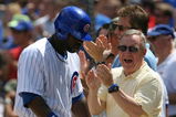 CHICAGO - JULY 26: Senator Richard Durbin (D-IL) joins Chicago Cub fans in cheering Milton Bradley #21 after Bradley scored a run on a play at the plate in the 3rd inning against the Cincinnati Reds on July 26, 2009 at Wrigley Field in Chicago, Illinois. (Photo by Jonathan Daniel/Getty Images)