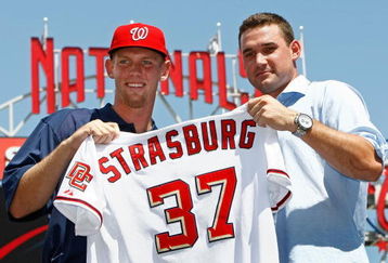 WASHINGTON - AUGUST 21:  Stephen Strasburg (L), the overall first pick in the 2009 MLB Draft, is presented with his jersey by Nationals third baseman Ryan Zimmerman (R) after being introduced at Nationals Park August 21, 2009 in Washington, DC. Strasburg, a right handed pitcher from San Diego State University, signed with the Nationals earlier this week wth a record contract for an amateur player.  (Photo by Win McNamee/Getty Images)