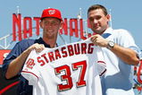 WASHINGTON - AUGUST 21:  Stephen Strasburg (L), the overall first pick in the 2009 MLB Draft, is presented with his jersey by Nationals third baseman Ryan Zimmerman (R) after being introduced at Nationals Park August 21, 2009 in Washington, DC. Strasburg, a right handed pitcher from San Diego State University, signed with the Nationals earlier this week wth a record contract for an amateur player.  (Photo by Win McNamee/Getty Images)