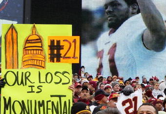 LANDOVER, MD - DECEMBER 02:  A fan of the Washington Redskins hold up a sign honoring the late Sean Taylor prior to the game against the Buffalo Bills on December 2, 2007 at FedEx Field in Landover, Maryland.  (Photo by Jim McIsaac/Getty Images)