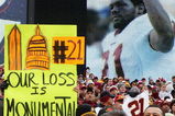 LANDOVER, MD - DECEMBER 02:  A fan of the Washington Redskins hold up a sign honoring the late Sean Taylor prior to the game against the Buffalo Bills on December 2, 2007 at FedEx Field in Landover, Maryland.  (Photo by Jim McIsaac/Getty Images)