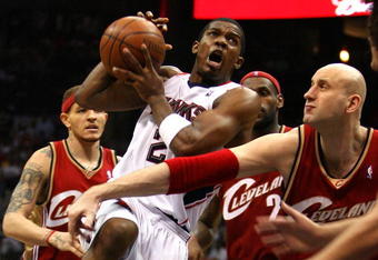 ATLANTA - MAY 09:  Joe Johnson #2 of the Atlanta Hawks drives against Zydrunas Ilgauskas #11 of the Cleveland Cavaliers in Game Three of the Eastern Conference Semifinals during the 2009 NBA Playoffs at Philips Arena on May 9, 2009 in Atlanta, Georgia.  NOTE TO USER: User expressly acknowledges and agrees that, by downloading and/or using this Photograph, user is consenting to the terms and conditions of the Getty Images License Agreement.  (Photo by Andy Lyons/Getty Images)