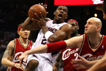 ATLANTA - MAY 09:  Joe Johnson #2 of the Atlanta Hawks drives against Zydrunas Ilgauskas #11 of the Cleveland Cavaliers in Game Three of the Eastern Conference Semifinals during the 2009 NBA Playoffs at Philips Arena on May 9, 2009 in Atlanta, Georgia.  NOTE TO USER: User expressly acknowledges and agrees that, by downloading and/or using this Photograph, user is consenting to the terms and conditions of the Getty Images License Agreement.  (Photo by Andy Lyons/Getty Images)