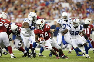 GLENDALE, AZ - SEPTEMBER 27:  Running back Tim Hightower #34 of the Arizona Cardinals is tackled for a loss by Ed Johnson #92 of the Indianapolis Colts in the second quarter during the game at University of Phoenix Stadium on September 27, 2009 in Glendale, Arizona. (Photo by Christian Petersen/Getty Images)