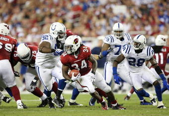 GLENDALE, AZ - SEPTEMBER 27:  Running back Tim Hightower #34 of the Arizona Cardinals is tackled for a loss by Ed Johnson #92 of the Indianapolis Colts in the second quarter during the game at University of Phoenix Stadium on September 27, 2009 in Glendale, Arizona. (Photo by Christian Petersen/Getty Images)