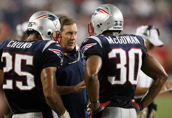 FOXBORO, MA - AUGUST 20:  Head coach Bill Belichick of the New England Patriots talks with Pat Chung #25 and Brandon McGowan #30 against the Cincinnati Bengals during their preseason game at Gillette Stadium on August 20, 2009 in Foxboro, Massachusetts.  (Photo by Jim Rogash/Getty Images)