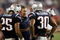 FOXBORO, MA - AUGUST 20:  Head coach Bill Belichick of the New England Patriots talks with Pat Chung #25 and Brandon McGowan #30 against the Cincinnati Bengals during their preseason game at Gillette Stadium on August 20, 2009 in Foxboro, Massachusetts.  (Photo by Jim Rogash/Getty Images)