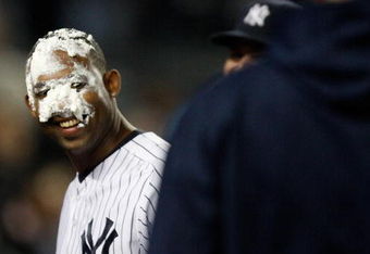 NEW YORK - SEPTEMBER 29: Juan Miranda #72 of the New York Yankees smiles back at AJ Burnett after he whipped cream in the face for hitting the game winning RBI single against the Kansas City Royals during the game on September 29, 2009 at Yankee Stadium in the Bronx borough of New York City. (Photo by Jared Wickerham/Getty Images)