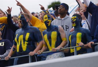 MORGANTOWN, WV - OCTOBER 26:  Fans of the West Virginia University Mountaineers cheer on their team during a Big East game against the University of Miami Hurricanes on October 26, 2002 at Mountaineer Field in Morgantown, West Virginia . Miami won 40-23.  (Photo By Doug Pensinger/Getty Images)