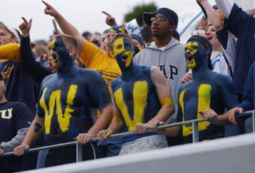 MORGANTOWN, WV - OCTOBER 26:  Fans of the West Virginia University Mountaineers cheer on their team during a Big East game against the University of Miami Hurricanes on October 26, 2002 at Mountaineer Field in Morgantown, West Virginia . Miami won 40-23.  (Photo By Doug Pensinger/Getty Images)
