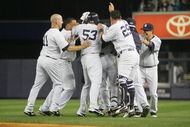 NEW YORK - SEPTEMBER 29: Members of the New York Yankees celebrate around Juan Miranda #72 after he hit the game winning RBI single agaist the Kansas City Royals during the game on September 29, 2009 at Yankee Stadium in the Bronx borough of New York City. (Photo by Jared Wickerham/Getty Images)