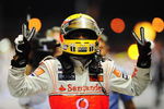 SINGAPORE - SEPTEMBER 27:  Lewis Hamilton of Great Britain and McLaren Mercedes celebrates in parc ferme after winning the Singapore Formula One Grand Prix at the Marina Bay Street Circuit on September 27, 2009 in Singapore.  (Photo by Clive Mason/Getty Images)