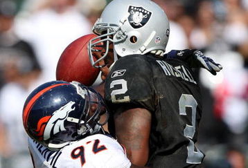 OAKLAND, CA - SEPTEMBER 27:  JaMarcus Russell #2 of the Oakland Raiders is sacked by Elvis Dumervil #92 of the Denver Broncos on September 27, 2009 during an NFL game at the Oakland-Alameda County Coliseum in Oakland, California.  (Photo by Jed Jacobsohn/Getty Images)