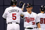 MINNEAPOLIS - JUNE 14:  Michael Cuddyer #5 of the Minnesota Twins is congratulated by teammate Luis Rodriguez #38 after Cuddyer hit a solo home run in the fifth inning against the San Francisco Giants on June 14, 2005 at the Hubert H. Humphrey Metrodome in Minneapolis, Minnesota.  (Photo by Elsa/Getty Images)