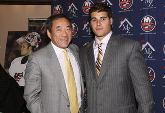 UNIONDALE, NY - SEPTEMBER 12:  Team owner Charles Wang (L) with goaltender Rick DiPietro (R) after DiPietro signed a 15 year contract with the New York Islanders on September 12, 2006 at Nassau Coliseum in Uniondale, New York.  (Photo by Bruce Bennett/Getty Images)