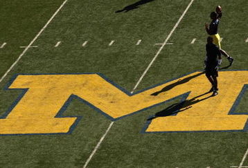 ANN ARBOR, MI - SEPTEMBER 19:  Michigan Wolverines players warm up for their game with the Eastern Michigan Eagles at Michigan Stadium on September 19, 2009 in Ann Arbor, Michigan.  (Photo by Stephen Dunn/Getty Images)