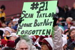 LANDOVER, MD - DECEMBER 02:  A fan of the Washington Redskins hold up a sign honoring the late Sean Taylor prior to the game against the Buffalo Bills on December 2, 2007 at FedEx Field in Landover, Maryland.  (Photo by Jim McIsaac/Getty Images)