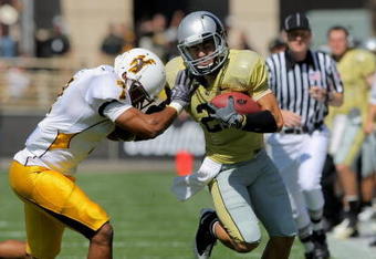 BOULDER, CO - SEPTEMBER 19:  Wide reciever Scotty McKnight #21 of the Colorado Buffaloes makes a reception for a first down before being forced out of bounds by Shamiel Gary #7 of the Wyoming Cowboys at Folsom Field on September 19, 2009 in Boulder, Colorado. The Buffaloes defeated the Cowboys 24-0.  (Photo by Doug Pensinger/Getty Images)