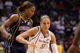 PHOENIX - SEPTEMBER 29:  Diana Taurasi #3 of the Phoenix Mercury drives past Tamika Catchings #24 of the Indiana Fever in Game One of the 2009 WNBA Finals at US Airways Center on August 29, 2009 in Phoenix, Arizona. The Mercury defeated the Fever 120-116 in overtime to take a 1-0 series lead. NOTE TO USER: User expressly acknowledges and agrees that, by downloading and or using this photograph, User is consenting to the terms and conditions of the Getty Images License Agreement.  (Photo by Christian Petersen/Getty Images)