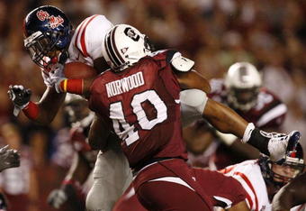 COLUMBIA, SC - SEPTEMBER 24:  Linebacker Eric Norwood #40 of the South Carolina Gamecocks tackles running back Cordera Eason #25 of the Mississippi Rebels during their game at Williams-Brice Stadium on September 24, 2009 in Columbia, South Carolina. (Photo by Streeter Lecka/Getty Images)
