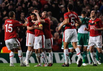 MANCHESTER, ENGLAND - SEPTEMBER 30:  Ryan Giggs of Manchester United is congratulated by his team mates after scoring his team's first goal during the UEFA Champions League Group B match between Manchester United and VfL Wolfsburg at Old Trafford on September 30, 2009 in Manchester, England.  (Photo by Michael Regan/Getty Images)