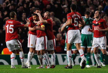 MANCHESTER, ENGLAND - SEPTEMBER 30:  Ryan Giggs of Manchester United is congratulated by his team mates after scoring his team's first goal during the UEFA Champions League Group B match between Manchester United and VfL Wolfsburg at Old Trafford on September 30, 2009 in Manchester, England.  (Photo by Michael Regan/Getty Images)