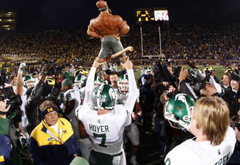 ANN ARBOR, MI - OCTOBER 25:  Brian Hoyer #7 of the Michigan State Spartans holds up the Paul Bunyan trophy after beating the Michigan Wolverines 35-21 on October 25, 2008 at Michigan Stadium in Ann Arbor, Michigan.  (Photo by Gregory Shamus/Getty Images)