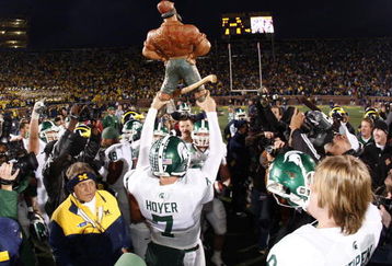 ANN ARBOR, MI - OCTOBER 25:  Brian Hoyer #7 of the Michigan State Spartans holds up the Paul Bunyan trophy after beating the Michigan Wolverines 35-21 on October 25, 2008 at Michigan Stadium in Ann Arbor, Michigan.  (Photo by Gregory Shamus/Getty Images)