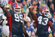 ORCHARD PARK, NY - SEPTEMBER 27: Marcus Stroud #99 and Bryan Scott #43 of the Buffalo Bills motions for possession during the game against the New Orleans Saints at Ralph Wilson Stadium on September 27, 2009 in Orchard Park, New York. (Photo by Rick Stewart/Getty Images)