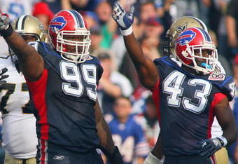 ORCHARD PARK, NY - SEPTEMBER 27: Marcus Stroud #99 and Bryan Scott #43 of the Buffalo Bills motions for possession during the game against the New Orleans Saints at Ralph Wilson Stadium on September 27, 2009 in Orchard Park, New York. (Photo by Rick Stewart/Getty Images)