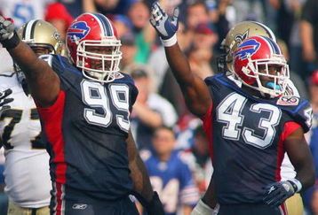 ORCHARD PARK, NY - SEPTEMBER 27: Marcus Stroud #99 and Bryan Scott #43 of the Buffalo Bills motions for possession during the game against the New Orleans Saints at Ralph Wilson Stadium on September 27, 2009 in Orchard Park, New York. (Photo by Rick Stewart/Getty Images)