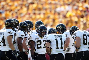 CHESTNUT HILL, MA - SEPTEMBER 26:  Quarterback Riley Skinner #11 of the Wake Forest Demon Deacons calls the play in the huddle in the first half against the Boston College Eagles on September 26, 2009 at Alumni Stadium in Chestnut Hill, Massachusetts.  (Photo by Elsa/Getty Images)