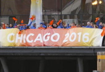 COPENHAGEN, DENMARK - OCTOBER 1:  Supporters of Chicago 2016 cheer as a boat carrying IOC members to  the opening ceremonies of the the 121st International Olympic Committee (IOC) Session and XIII Olympic Congress at the Copenhagen Opera House passes on October 1, 2009 in Copenhagen, Denmark. The 121st session of the International Olympic Committee (IOC) will vote on October 2 on whether Chicago, Tokyo, Rio de Janeiro or Madrid will host the 2016 Olympic Games. (Photo by Charles Dharapak-Pool/Getty Images)