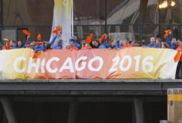 COPENHAGEN, DENMARK - OCTOBER 1:  Supporters of Chicago 2016 cheer as a boat carrying IOC members to  the opening ceremonies of the the 121st International Olympic Committee (IOC) Session and XIII Olympic Congress at the Copenhagen Opera House passes on October 1, 2009 in Copenhagen, Denmark. The 121st session of the International Olympic Committee (IOC) will vote on October 2 on whether Chicago, Tokyo, Rio de Janeiro or Madrid will host the 2016 Olympic Games. (Photo by Charles Dharapak-Pool/Getty Images)