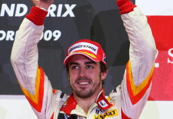 SINGAPORE - SEPTEMBER 27:  Fernando Alonso of Spain and Renault celebrates on the podium after finishing third during the Singapore Formula One Grand Prix at the Marina Bay Street Circuit on September 27, 2009 in Singapore.  (Photo by Mark Thompson/Getty Images)