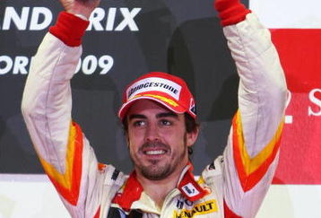 SINGAPORE - SEPTEMBER 27:  Fernando Alonso of Spain and Renault celebrates on the podium after finishing third during the Singapore Formula One Grand Prix at the Marina Bay Street Circuit on September 27, 2009 in Singapore.  (Photo by Mark Thompson/Getty Images)