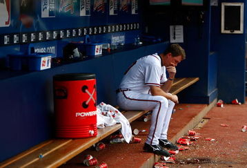 ATLANTA - JUNE 27:  Chipper Jones #10 of the Atlanta Braves sits dejected in the dugout after falling to the Boston Red Sox 1-0 at Turner Field on June 27, 2009 in Atlanta, Georgia.  (Photo by Kevin C. Cox/Getty Images)