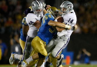 PASADENA, CA - SEPTEMBER 19:  Quarterback Carson Coffman #14 of the Kansas State Wildcats is hit by Kyle Bosworth #54 of the UCLA Bruins in the first half at the Rose Bowl on September 19, 2009 in Pasadena, California.  (Photo by Jeff Gross/Getty Images)