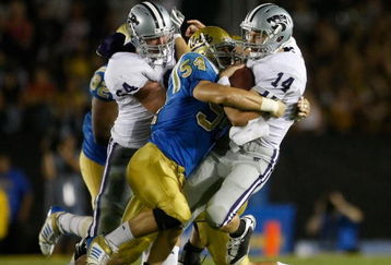PASADENA, CA - SEPTEMBER 19:  Quarterback Carson Coffman #14 of the Kansas State Wildcats is hit by Kyle Bosworth #54 of the UCLA Bruins in the first half at the Rose Bowl on September 19, 2009 in Pasadena, California.  (Photo by Jeff Gross/Getty Images)