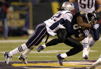 BALTIMORE - DECEMBER 3:  Derrick Mason #85 of the Baltimore Ravens is tackled by Asante Samuel #22 of the New England Patriots at M&T Bank Stadium December 3, 2007 in Baltimore, Maryland.  (Photo by Greg Fiume/Getty Images)