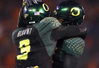 SAN DIEGO, CA - DECEMBER 30:   Runningback LeGarrette Blount #9 of the University of Oregon Ducks celebrates his touchdown with a teammate during his team's 42-31 win over the Oklahoma State University Cowboys in the Pacific Life Holiday Bowl at Qualcomm Stadium on December 30, 2008 in San Diego, California. (Photo by Donald Miralle/Getty Images)