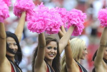 TAMPA, FL - OCTOBER 12: Cheerleaders of the Tampa Bay Buccaneers carry pink pom poms to support breast cancer awareness during play against the Carolina Panthers at Raymond James Stadium on October 12, 2008 in Tampa, Florida.  (Photo by Al Messerschmidt/Getty Images)