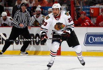 DETROIT - MAY 27:  Dustin Byfuglien #33 of the Chicago Blackhawks skates against the Detroit Red Wings during Game Five of the Western Conference Championship Round of the 2009 Stanley Cup Playoffs on May 27, 2009 at Joe Louis Arena in Detroit, Michigan. The Red Wings won 2-1 in overtime. (Photo by Gregory Shamus/Getty Images)