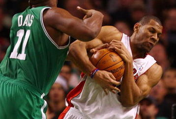 BOSTON - DECEMBER 07:  Joey Graham #14 of the Toronto Raptors grabs the ball from Glen Davis #11 of the Boston Celtics on December 7, 2007 at the TD Banknorth Garden in Boston, Massachusetts. NOTE TO USER: User expressly acknowledges and agrees that, by downloading and or using this Photograph, user is consenting to the terms and conditions of the Getty Images License Agreement.  (Photo by Elsa/Getty Images)