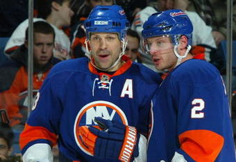 UNIONDALE, NY - APRIL 12:  Doug Weight #93 and Mark Streit #2 of the New York Islanders talk during a break against the the Boston Bruins on April 12, 2009 at Nassau Coliseum in Uniondale, New York. The Bruins won the game 6-2.  (Photo by Jim McIsaac/Getty Images)