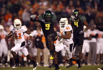 SAN DIEGO, CA - DECEMBER 30:   Runningback LeGarrette Blount #9 of the University of Oregon Ducks hurdles a player en route to a touchdown during his team's 42-31 win over the Oklahoma State University Cowboys in the Pacific Life Holiday Bowl at Qualcomm Stadium on December 30, 2008 in San Diego, California. (Photo by Donald Miralle/Getty Images)
