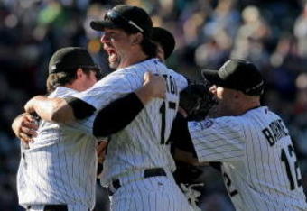DENVER - OCTOBER 01:  Ian Stewart #9, Todd Helton #17, Troy Tulowitzki #2 and Clint Barmes #12 of the Colorado Rockies celebrate after the final out as they defeated the Milwaukee Brewers 9-2 and clinched a National League playoff berth at Coors Field on October 1, 2009 in Denver, Colorado.  (Photo by Doug Pensinger/Getty Images)