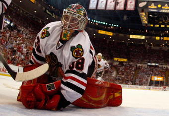 DETROIT - MAY 27:  Cristobal Huet #38 of the Chicago Blackhawks looks back behind the net against the Detroit Red Wings during Game Five of the Western Conference Championship Round of the 2009 Stanley Cup Playoffs on May 27, 2009 at Joe Louis Arena in Detroit, Michigan.  (Photo by Gregory Shamus/Getty Images)