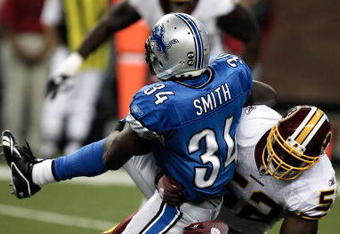 DETROIT, MI - SEPTEMBER 27: Running back Kevin Smith #34 of the Detroit Lions runs with the football as he is tackled by linebacker Rocky McIntosh #52 of the Washington Redsklns at Ford Field on September 27, 2009 in Detroit, Michigan. (Photo by Scott Boehm/Getty Images)